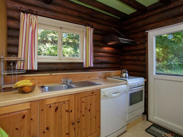 Open Wooden Chalet Built Against A Hill