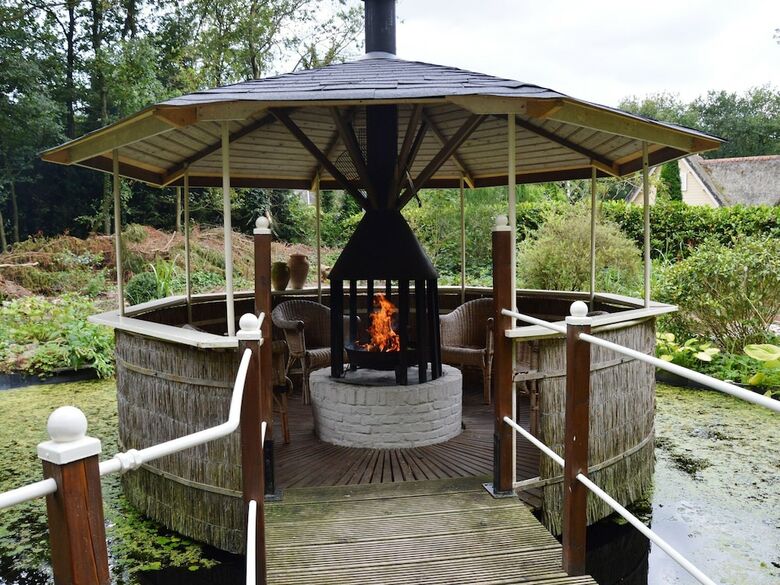 A Detached Bungalow With Outdoor Fireplace, Covered Terrace And Pond In A Forest Plot